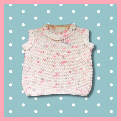 White sleeveless sweater with pink dots