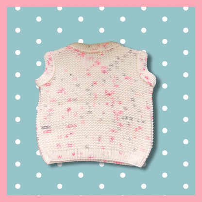 White sleeveless sweater with pink dots